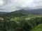 High-angle of Hanalei river valley gloomy cloudy sky background misty mountains, Hawai