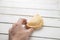 High angle of a male holding a delicious empanada on a wooden table