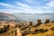 High-angle of a Ninamarca with castles and yellow grass, foggy mountains in the background