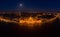 High angle panorama aerial drone shot of front facade of Hungarian Parliament with lights