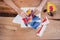 High angle photo of ladys hands do scrapbooking on wooden table