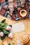 High angle on pink roses on wooden desk with cup of coffee and b