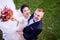 High angle portrait of cheerful wedding couple standing on grassy field