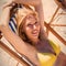 High angle portrait of woman relaxaing on lounge chair at beach