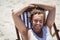 High angle portrait of woman relaxaing on lounge chair at beach