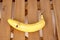 High angle shot of a banana on a wooden surface