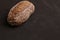 High angle shot of black bread on a monochrome background