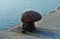 High angle shot of a bollard on the stone pier of the sea