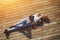 High angle shot of carefree young woman in summer glasses lying on the wooden jetty in the sun