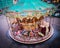 High angle shot of a carousel surrounded by buildings and lights in Montmartre in Paris, France