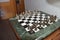 High angle shot of a chess board with realistic silver bronze pieces