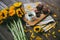 High angle shot of a cup of coffee and brownies on a table next to gorgeous sunflowers