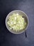 High angle shot of a cut cabbage in a grey bowl