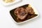 High angle shot of deliciously grilled pork meat on a plate isolated on a white background