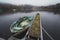 High angle shot of a dirty old boat parked near the pier in the lake