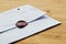 High angle shot of an envelope sealed with wax on a wooden surface