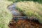 High angle shot of a flowing dirty stream in the Totenaasen Hills in Norway