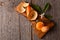 High angle shot of a  fresh peeled Minneola Tangelo on a cutting board with knife and orange blossoms and leaves