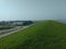 High angle shot of a greenfield with buildings near a beach