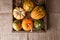 High angle shot of a group of autumn gourds, squash and pumpkins in a wood box on burlap