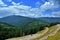 High angle shot of a landscape and the Transrarau road from the Rarau mountains in Romania