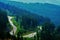 High angle shot of a landscape and the Transrarau road from the Rarau mountains in Romania