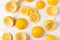 High angle shot of lemon rinds, whole lemons and lemon slices on a white marble kitchen surface