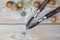 High angle shot of a nutcracker among hazelnuts scattered on a wooden surface