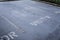 High angle shot of a parking lot with the text Visitor painted on the ground