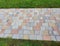 High angle shot of a paver walkway surrounded by green grass