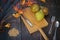 High angle shot of pears, cutlery, dried flowers, and grams of barley on a wooden cutting board