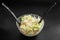 High-angle shot of a Peking cabbage salad in a bowl isolated on the black background