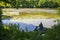 High angle shot of a person coarse fishing at a lake in Wiltshire, UK in the early morning