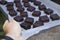 High angle shot of a person holding a trey with freshly-baked brownies