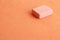 High angle shot of a pink eraser on orange background