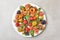 High angle shot of a plate full of homemade Holiday Almond Cookeies in various shapes and colors, animals, fruits, wreath,