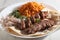 High angle shot of a plate of kebab with bread and onions and some spiced rice