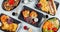 High angle shot of plates of colorful and traditional Japanese food on a table