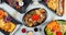 High angle shot of plates of colorful and traditional Japanese food on a table