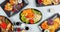 High angle shot of plates of colorful and traditional Japanese food on a table