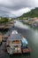 High angle shot of a river with lots of boats going along a coastal town