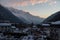 High angle shot of a rural area with snowy  houses against mesmerizing mountains