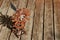 High angle shot of a rusted small windmill on a wooden surface