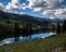 High-angle shot of a San Cristobal Colorado mountain lake with sky and trees reflected in the water