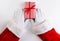 High angle shot of Santa Claus hands with a red and white striped Christmas Present