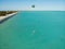 High angle shot of a sea with a person kitesurfing in the middle