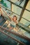 High angle shot of a sexy Caucasian girl in jeans shorts standing on stairs in abandoned building