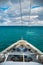 High angle shot of a ship with an overlooking view of blue ocean with a cloudy blue sky