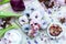 High angle shot of some blue and purple vegan donuts surrounded by flowers on a table