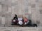 High angle shot of three women sitting on a bench near the wall - gossiping concept